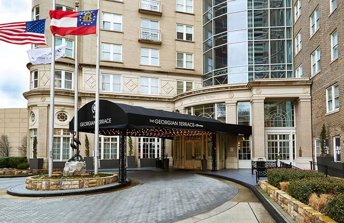 Hotel entrance with black awning labeled 