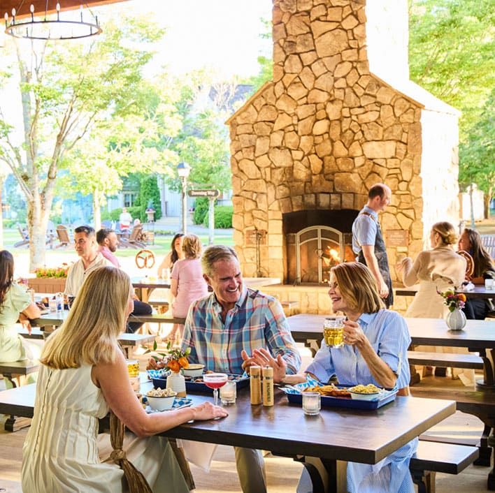 MICS Karaoke - A modern lounge with purple seating, mirrored walls, balloons hanging from the ceiling, and bottles on a glass table under blue accent lighting.