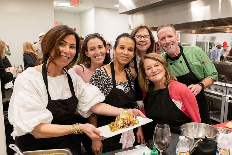 team of chefs showing off their culinary creation